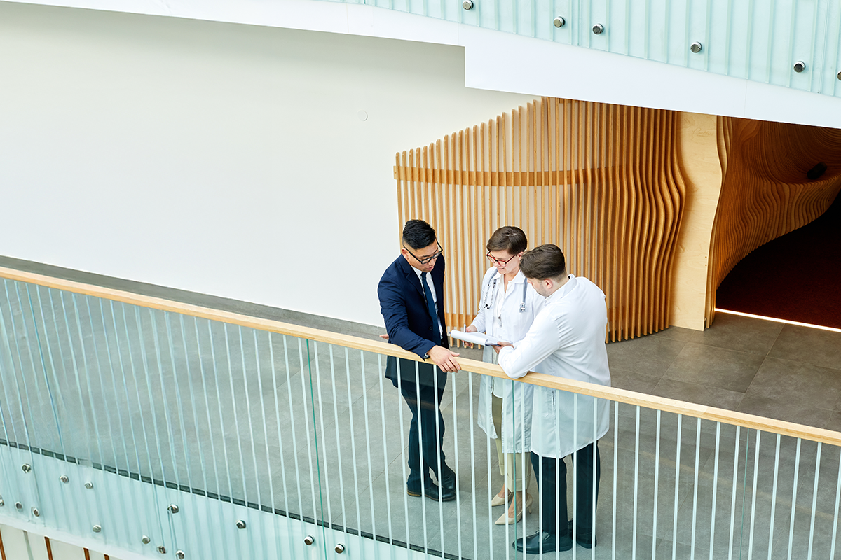 Three providers looking over a chart in a loft